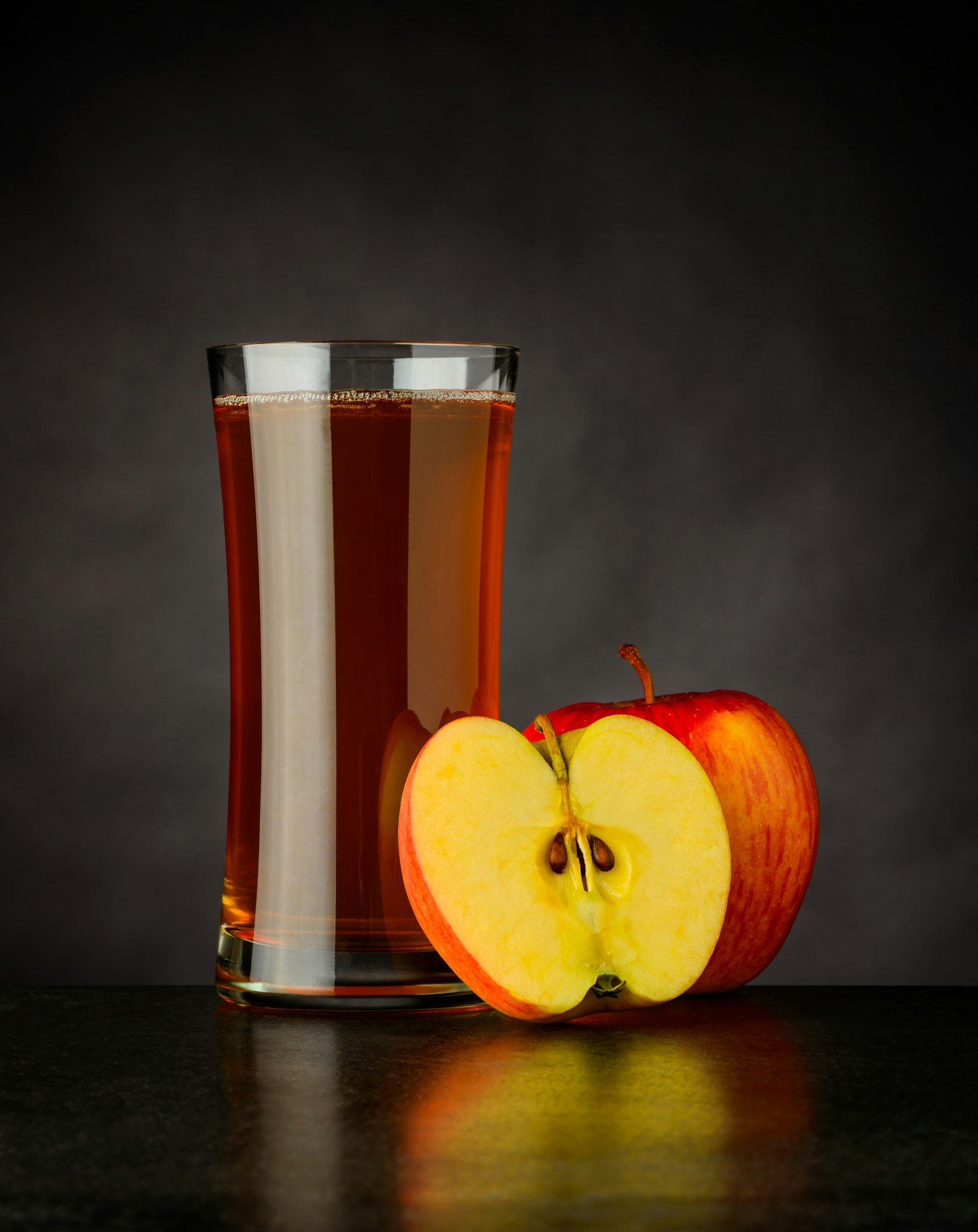 Organic Apple Juice on Dark Background